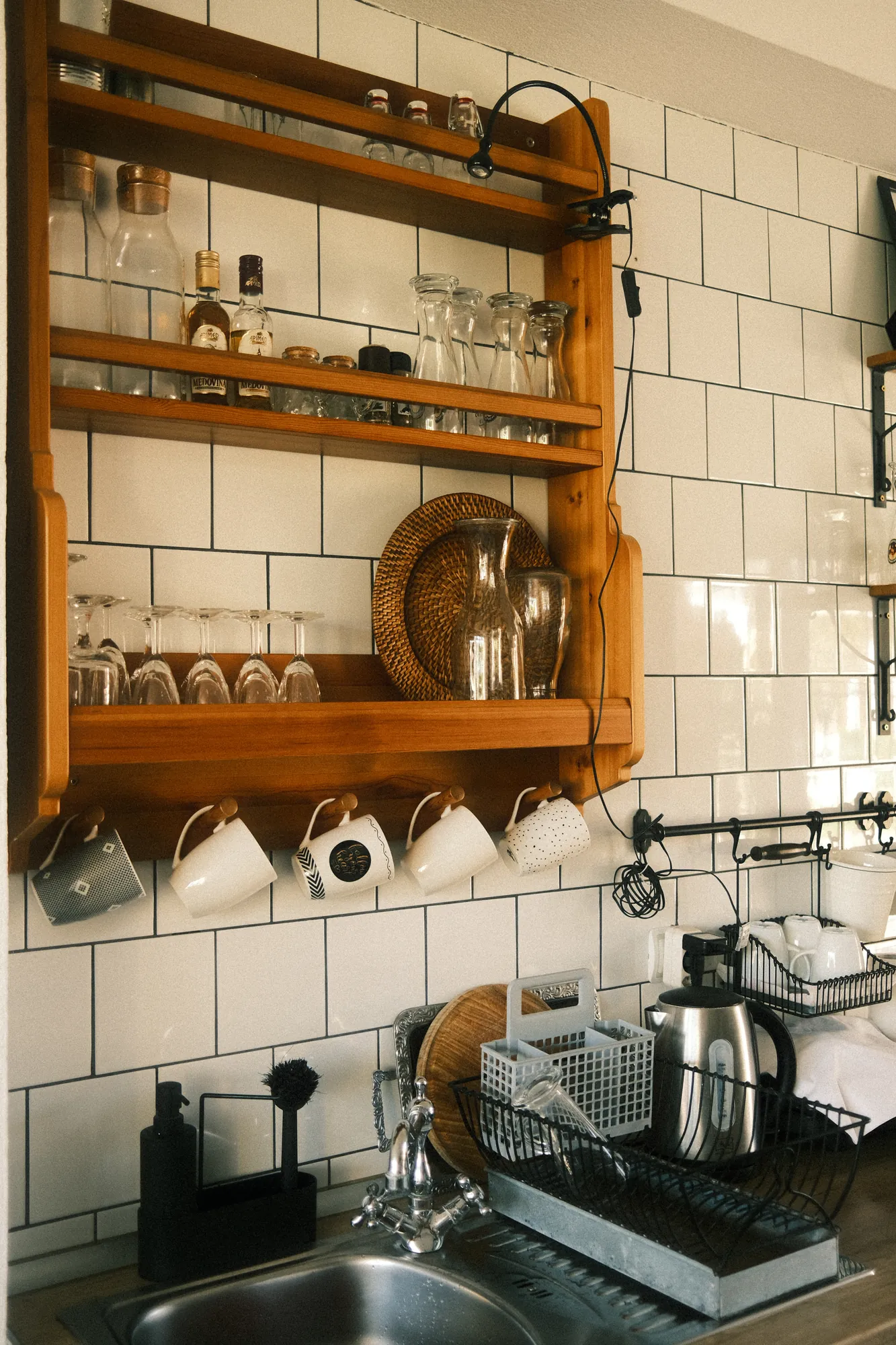 Modern kitchen interior featuring wooden shelving and organized dishware