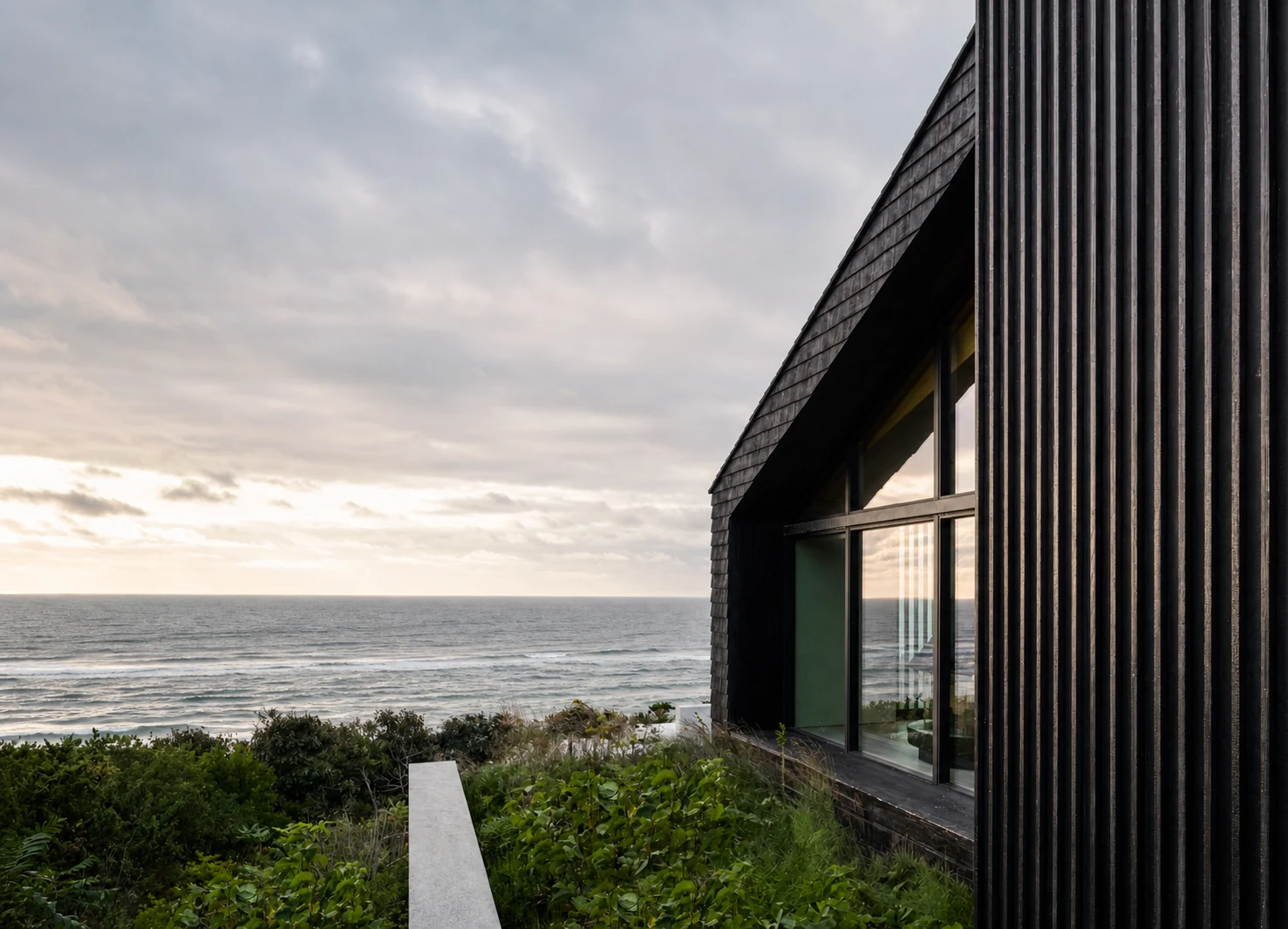 Montauk Cliff House black shingle facade beside the Atlantic in Montauk, New York, built by Hobbs Inc.